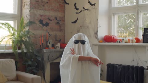 A Kid Wearing A Ghost Costume