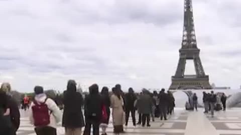 French artist JR unveiled Art installation visitors jumping "cliffs" below the Eiffel Tower in Paris