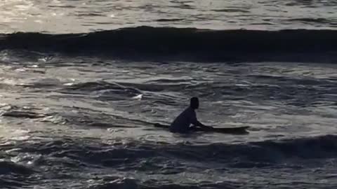 Guy rides white board with no fins