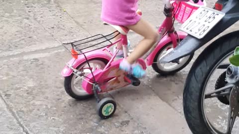 baby learns to ride a bicycle