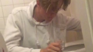 Guy in white shirt throwing up in toilet