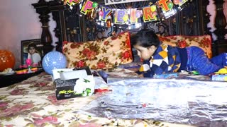 1 year old baby playing with Baloons and toys which he got on his 1st birthday