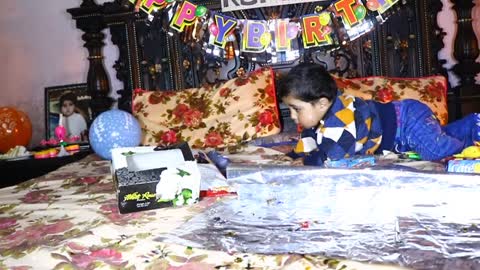 1 year old baby playing with Baloons and toys which he got on his 1st birthday
