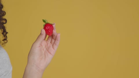 Close Up Shot of Young Adult Woman Holding Strawberry