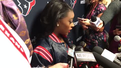 Simone Biles makes an appearance as a guest cheerleader for the Texans.