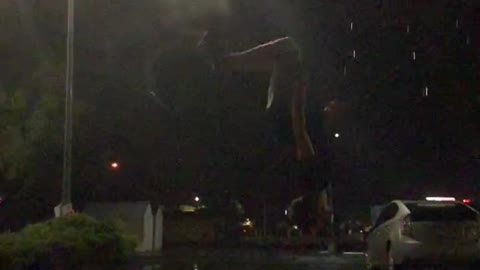 Landing a Backflip as the Lightning Strikes