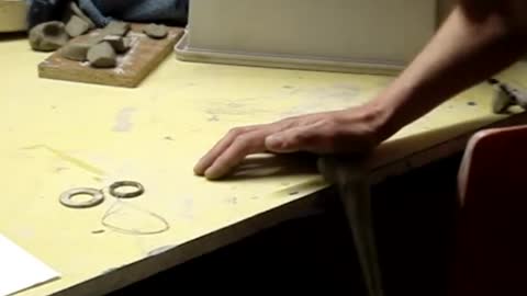 Making a clay pottery tea pot on the wheel