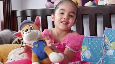 Little smiling girl with a stuffed toy