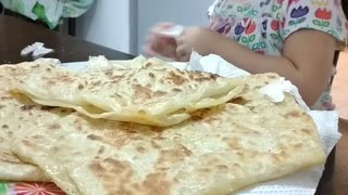 Lovely girl razane eating Moroccan roti canai