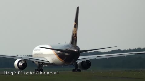 Boeing 767 take-off, 737 landing at Cologne-Bonn airport. Swarm of birds near runway.