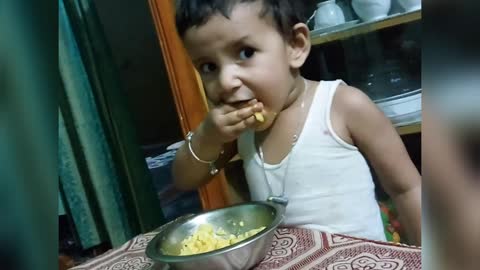 Sweet baby eating rice