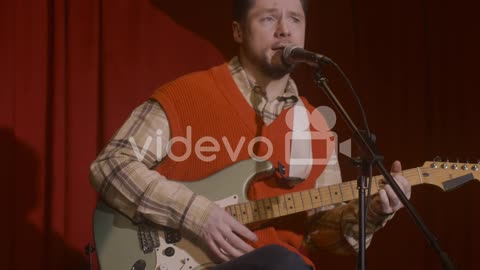 Male Musician Playing Guitar And Singing During Live Music Perfomance 2