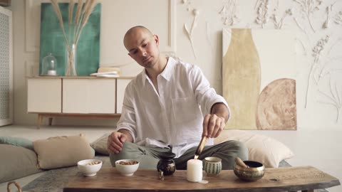 Man Burning A Palo Santo Stick