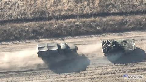 HD Drone footage on a small group of Russian IFV and truck moving on the road