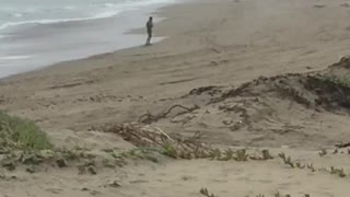 Man dancing practicing moves on beach
