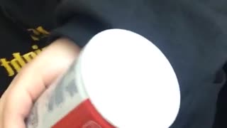 Girl sprays canned whipped cream in friend's mouth