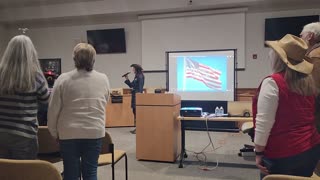 Christian Reagan’s wife, Hope, sings the Star-Spangled Banner at an event in Hendersonville, NC.