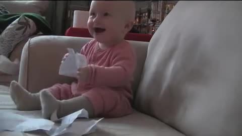 Baby laughing deadly at ripping of a paper