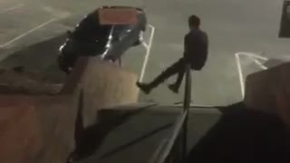 Guy sliding down night stairs spins all the way around rail