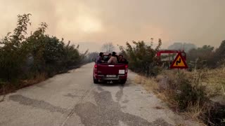 Greek firefighters tackling wildfire find migrants