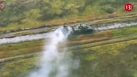 Crew members who started to run out of the burning Russian tank