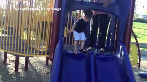 Unsuspecting Toddler zooms down the slide