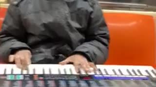 Man black jacket playing casio piano