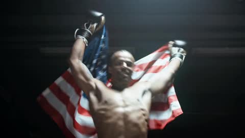 A Boxer Proudly Showing The American Flag In Victory