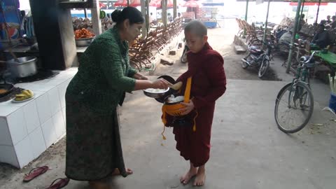 Walking with a Burmese, what do Burmese people make offerings to monks?