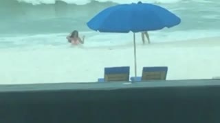 Woman narrates girl in ocean getting hit by wave