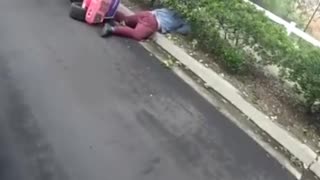 Man in pink toy jeep flips over