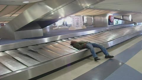 Sleeping Man Takes A Ride On Baggage Claim
