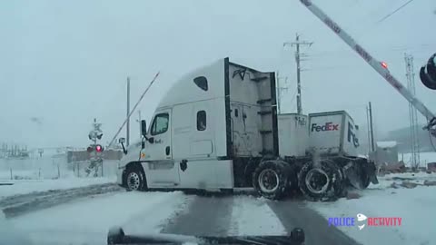 Police Dashcam Footage Captures Train Crashing Into FedEx Truck