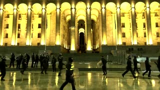 Protesters shield woman outside Georgia parliament