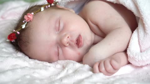 Newborn little baby girl is sleeping on the bed, sweet dreams of little baby, healthy sleep.