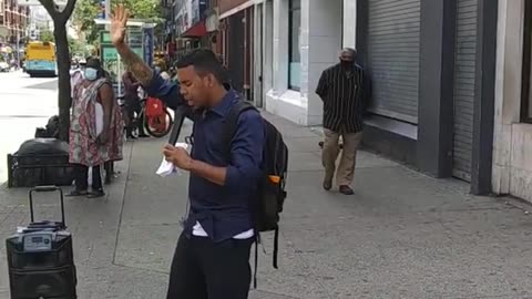 Young man Preaching the gospel in Spanish at W125st between Lenox Ave doing the Coronavirus Pandemic