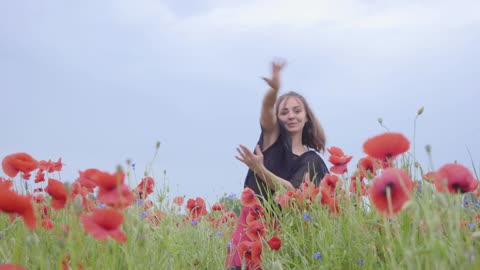 Girl dancing happily in a field of flowers