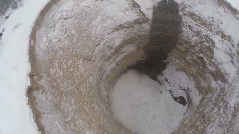 A huge hole in the ground on a flooded mine in Russia in the Urals city of Solikamsk - 4 max - shooting with flying robot