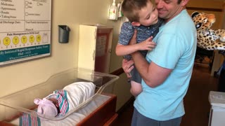 Brother meets baby sister for the first time