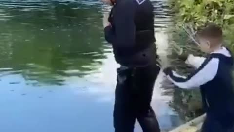 Police officer get thrown in the water