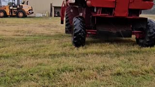 Moving a combine under a pole barn in the rain in the middle of being worked on farm Life