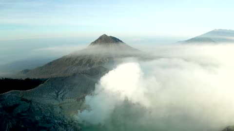 Volcano, steam and sky