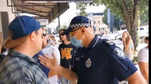 Queensland Australia - citizens standing Infront of businesses while police try shut them down