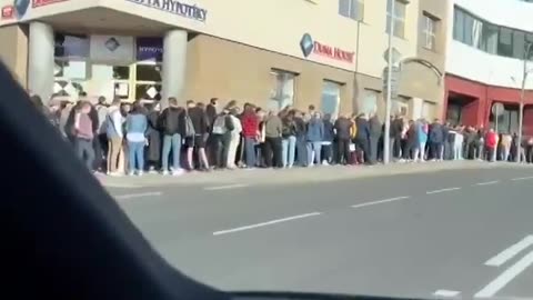 A huge line of Ukrainian refugees at the passport office in Prague. See description for more info