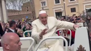 Pope Francis waves to Palm Sunday crowd