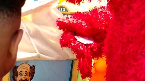 Houston mascot party character fed furry monster Elmo plays mr.noodle game in Elmo's room prop