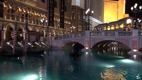 A Gondola Sailing in front of the Venetian Hotel (Las Vegas) in the Evening