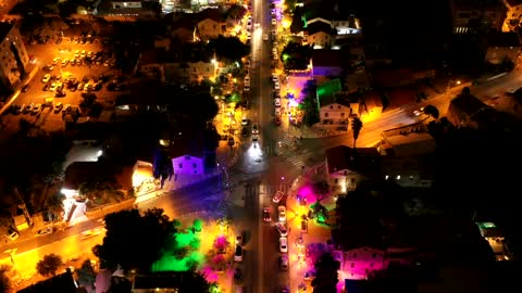 Helicopter view of Aerial Footage Of A Colorful Lights In The Street At Night