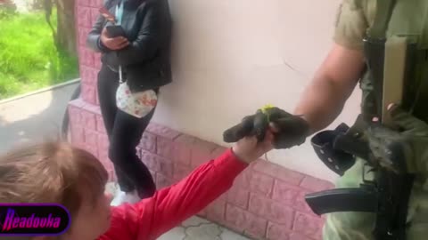 Girl thanked a Russian soldier by giving him a flower.