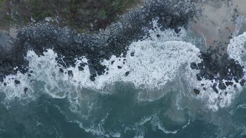 Top aerial shot of seashore with rocks
